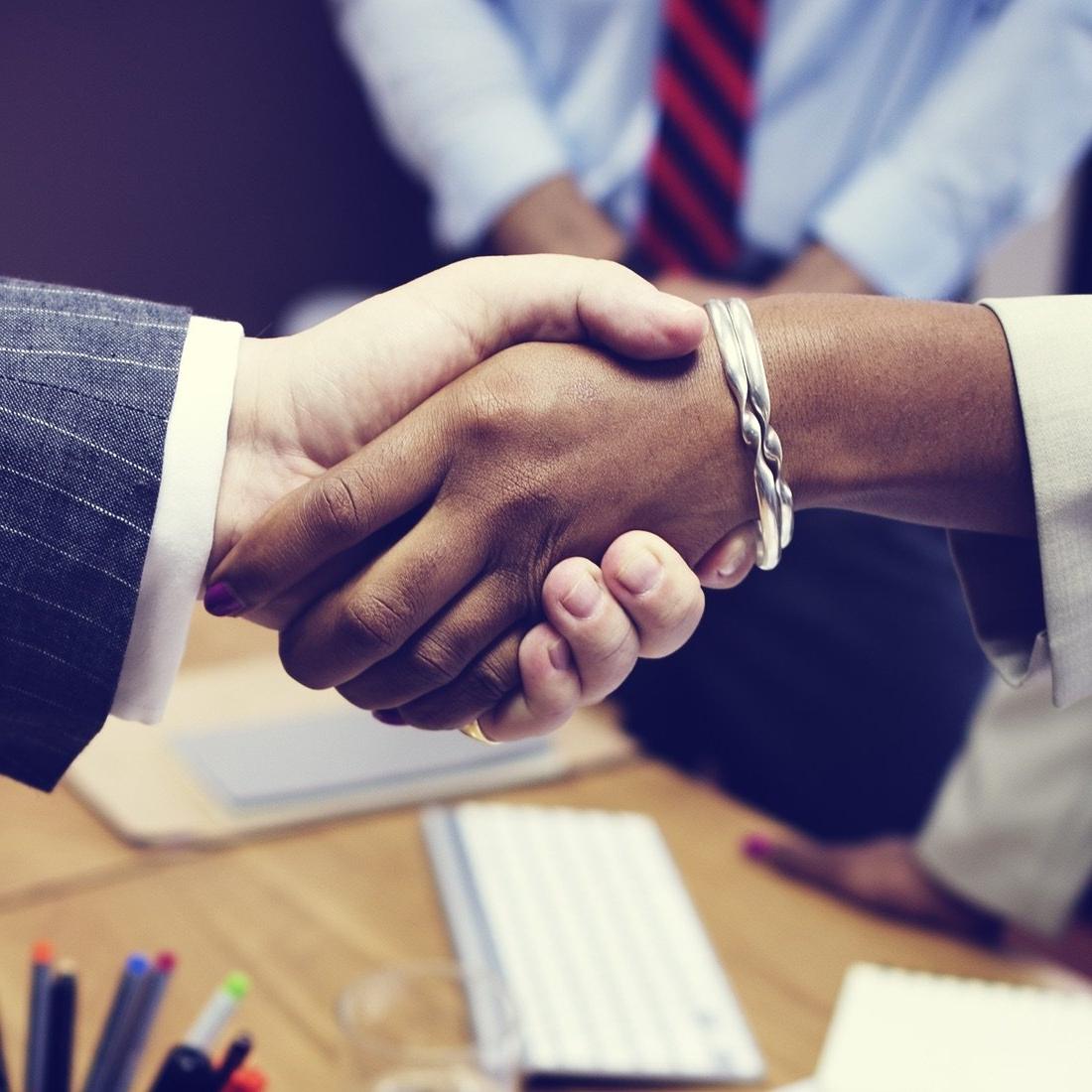 Handshake over table.